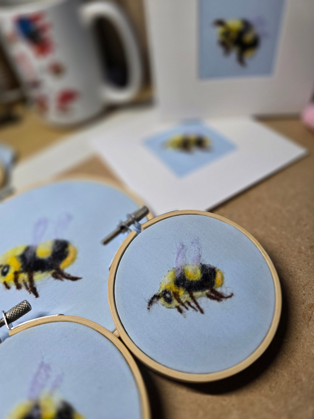 Bumble bee in hoops and on the front of  white cards, on a blue material