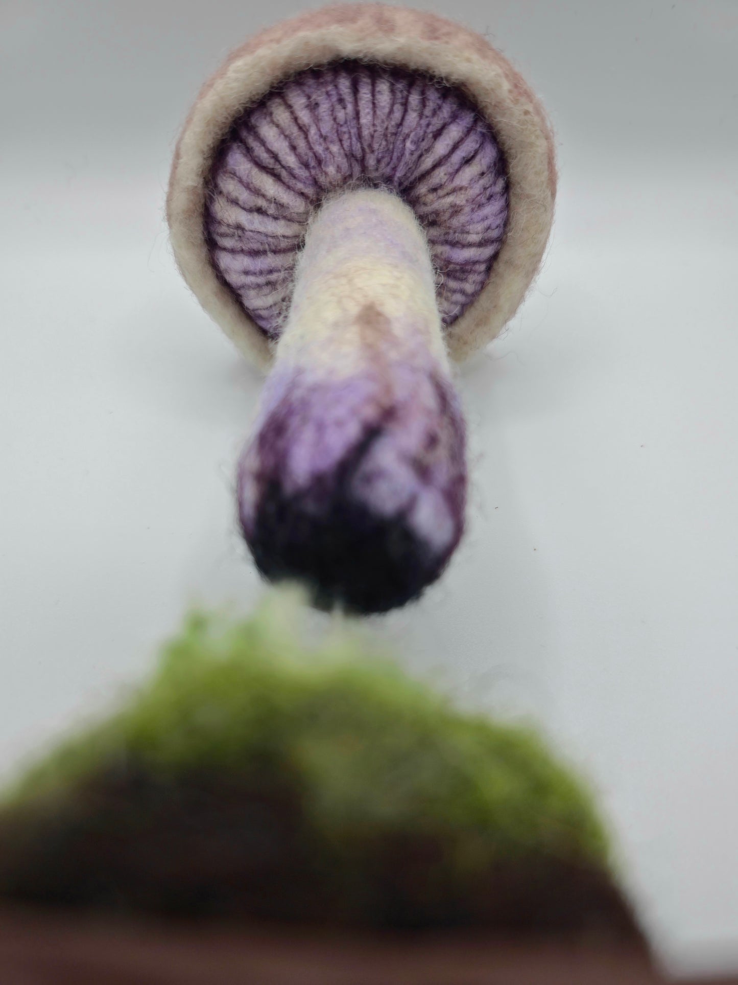 mushroom sculpture on its side on a white background